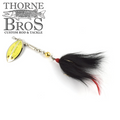 Inhaler Rattletail fishing lure featuring a silver and gold spinner blade, metallic beads, and a black feathered tail with a red tip for musky and fly fishing tackle.