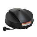 Black circular ION Blade Protector designed to cover and shield fishing tackle blades, featuring a central raised section and a securing cord with a pull toggle for safe attachment.