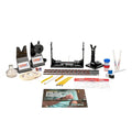 KRB Core Rod Building Kit laid out on a white surface, featuring rod drying stands, epoxy, thread spools, masking tape, rod guides, sanding sticks, and an instruction manual for custom fishing rod building.