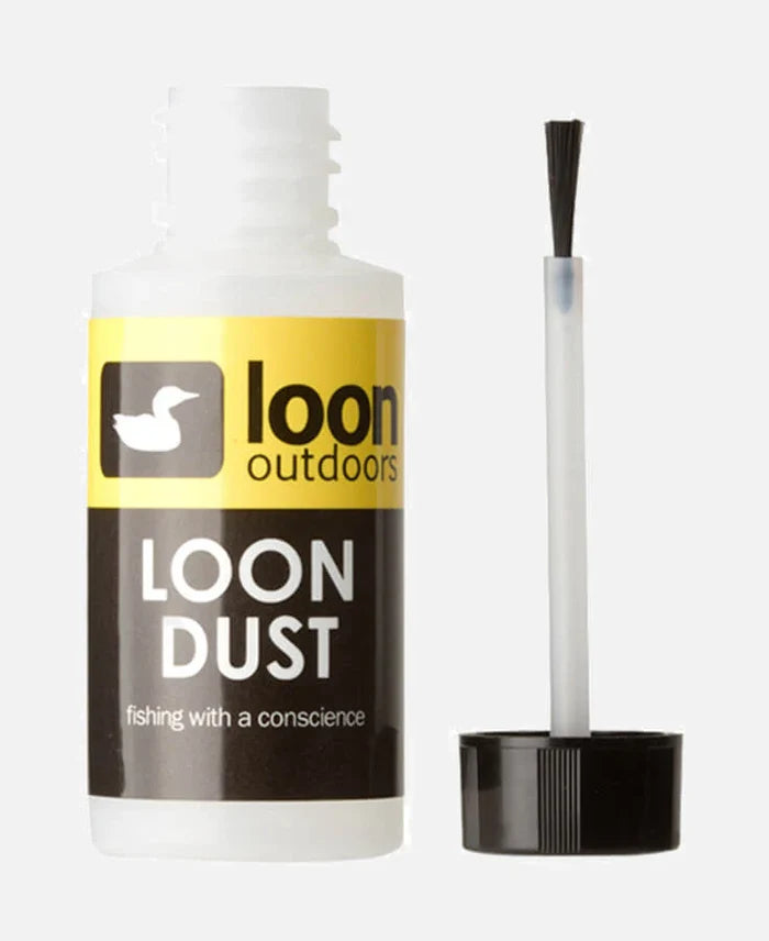 Bottle of Loon Dust with black cap removed, showing applicator brush, designed for cleaning and maintaining fishing tackle and gear.