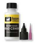 Bottle of Loon Water Based Head Cement System with yellow and black label, alongside a black screw-on cap with applicator tip and a separate pink precision nozzle, used for fishing tackle maintenance.