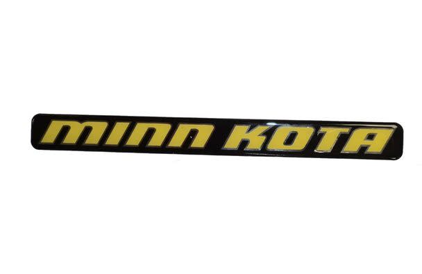 Minn Kota DECAL-SHIELD VNTG PMS123C(SUB) P/N: 2055611 featuring a black and yellow decal with bold lettering, used for marine electronics or fishing equipment branding.