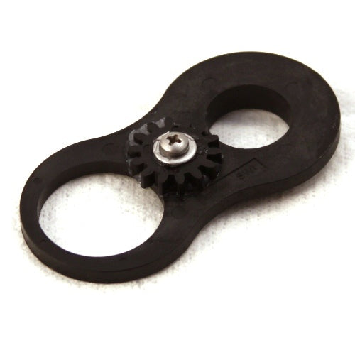 Close-up of a black Minn Kota GEAR/IDLER PLATE/SCREW/WASHER P/N: 2772215 featuring a gear mechanism with a central metal screw and washer on a white background, used for fishing tackle repair.