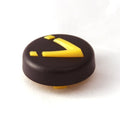 Minn Kota INDICATOR ASSY P/N: 2990140 is a small, round black component with raised yellow markings, designed for use in fishing tackle or marine electronics systems.