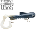 Musky Innovations TB Custom Ultra Dawg fishing lure in dark blue with a curved white soft tail and two sets of treble hooks, designed for musky fishing.