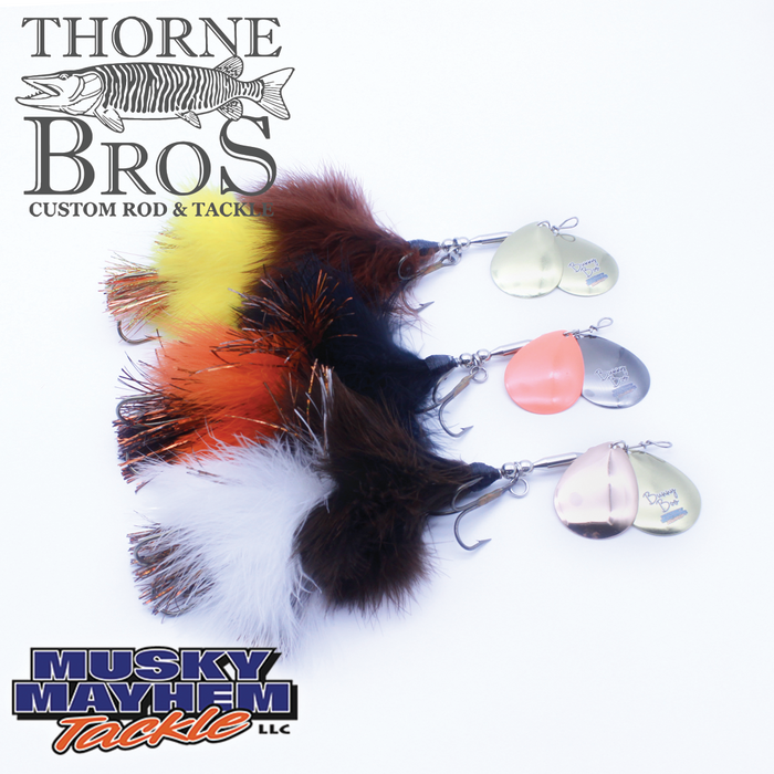 Musky Mayhem Bunny Boo fishing lures in yellow, orange, black, brown, and white with metal spinner blades, designed for musky fishing, displayed with Thorne Bros logo.