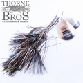 Musky Mayhem Detonator 13/10 fishing lure with black and metallic strands, designed for musky fishing, featuring a metal spinner blade and branded with Thorne Bros logo.