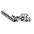 Nomad Design Tungsten Ball Pack showing a metal tube with multiple small, shiny tungsten balls used for fishing tackle customization and weighting.