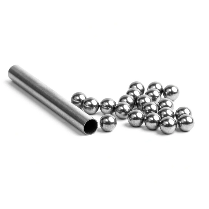 Nomad Design Tungsten Ball Pack showing a metal tube with multiple small, shiny tungsten balls used for fishing tackle customization and weighting.