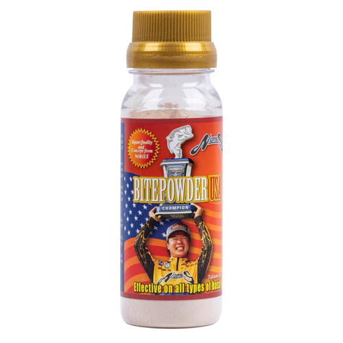 Clear plastic bottle with a gold screw cap labeled Nories Bite Powder USA, featuring an American flag background and an image of a smiling angler holding a trophy, designed for fishing tackle use.