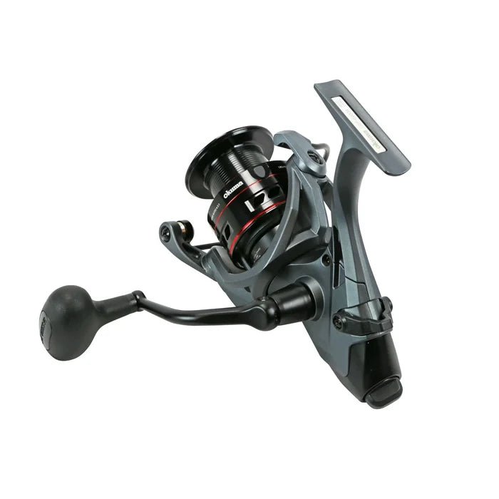 Okuma Ceymar A - Baitfeeder spinning reel in black and red with ergonomic handle, designed for smooth fishing performance and durability in various tackle setups.