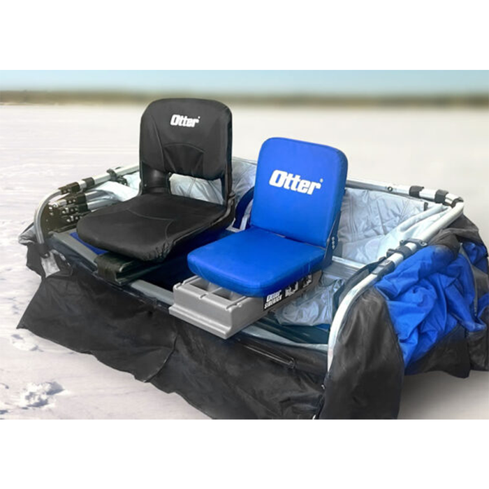 Two padded fishing boat seats mounted on a gray frame, one black and one blue, both labeled Otter, shown outdoors on a snowy surface, Otter Pro Sidekick Jump Seat - #201619.