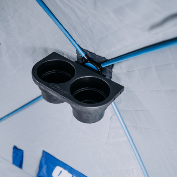 Otter QA Dual Cup Holder made of black durable plastic, mounted inside a blue and gray quilted fabric shelter, featuring two round cup slots for secure beverage storage.