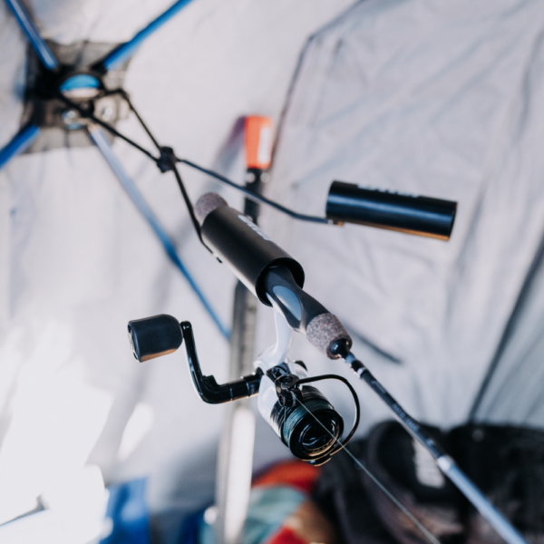 Otter QA Dual Rod Holder mounted inside a fishing shelter, securely holding two fishing rods with reels positioned horizontally for easy access during fishing.