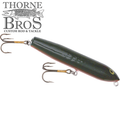 Poe's Giant Jackpot fishing lure with a sleek dark green body and two sharp treble hooks, designed for musky fishing, featured under Thorne Bros custom tackle branding.