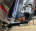 Close-up of a Precision Sonar Jackplate Mount installed on a boat, showing its sturdy metal construction, mounting bolts, and connection to marine electronics for fishing applications.