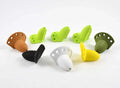 A group of colorful Rainy's Bisharat's Bubbleicious Diver Head fishing lures in brown, black, white, yellow, green, and olive colors arranged on a white background.
