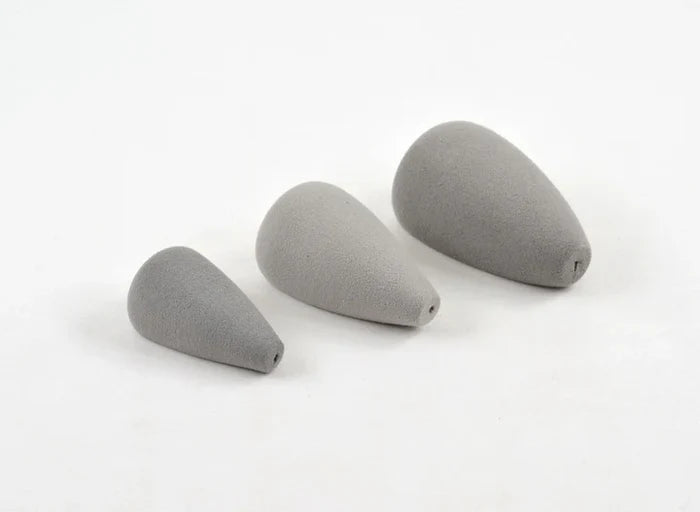 Three gray foam fishing lure components of varying sizes with tapered shapes and small holes at one end, identified as Rainy's Mouse Bodies for musky tackle and fishing gear.