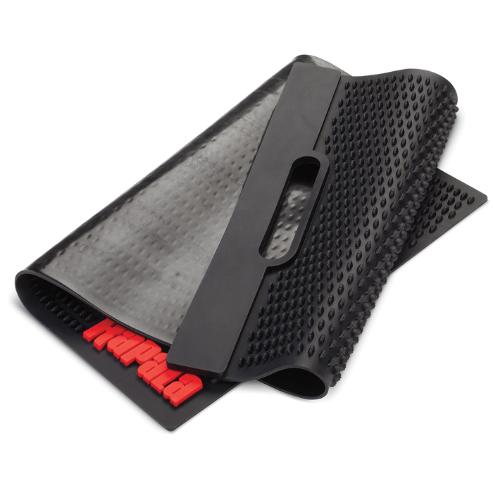 Rapala Fillet Mat made of durable black rubber with raised textured surface for slip resistance, featuring a handle cutout for easy carrying and red Rapala logo on one corner.