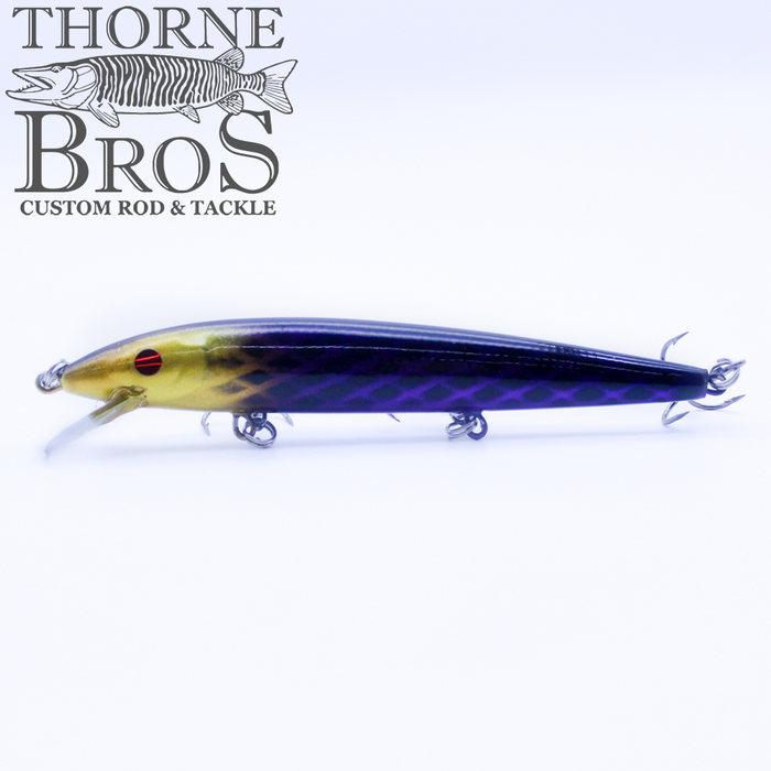 Rapala Husky Jerk - Custom Painted Colors fishing lure with a slender, elongated body in yellow and purple shades, equipped with multiple treble hooks for effective fishing tackle use.