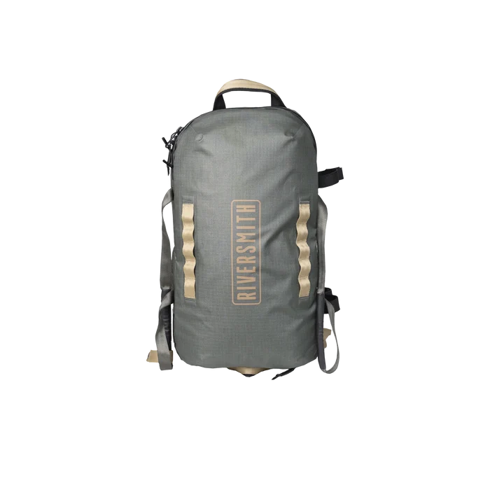 Riversmith Convoy Duffel in muted green with beige accents, featuring a front zipper pocket, top handle, and adjustable shoulder straps for durable outdoor fishing tackle storage.