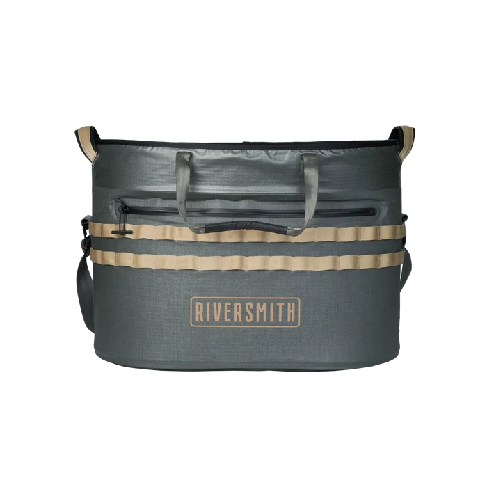Riversmith Convoy Hauler in dark green with tan webbing, featuring sturdy handles and a zippered pocket, designed for organizing fishing tackle and gear.