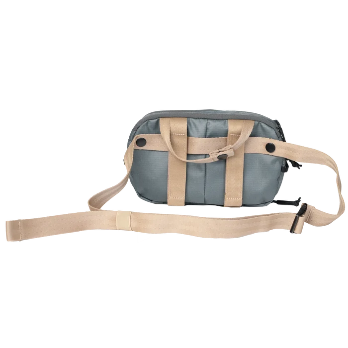 Riversmith Convoy Pack-Out Bag in muted green with beige adjustable straps, designed for organizing fishing tackle and gear during outdoor activities.