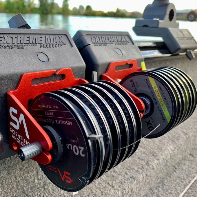 Scientific Anglers Outpost Tippet Holder mounted on a fishing boat, holding multiple spools of tippet line with a durable red and black design for organized fishing tackle.