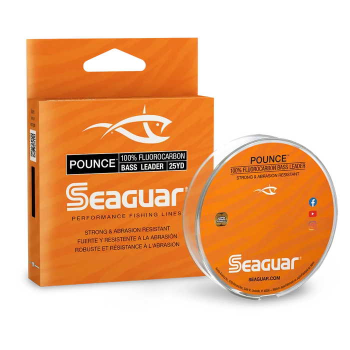 Spool and packaging of Seaguar Pounce Fluorocarbon fishing line in bright orange with branding and product details highlighting its strength and abrasion resistance for bass fishing use.