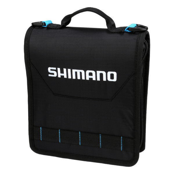 Black compact Shimano Baraja Tackle Bags with a top handle, blue zipper pulls, and white brand logo, designed for organized fishing tackle storage and easy transport.