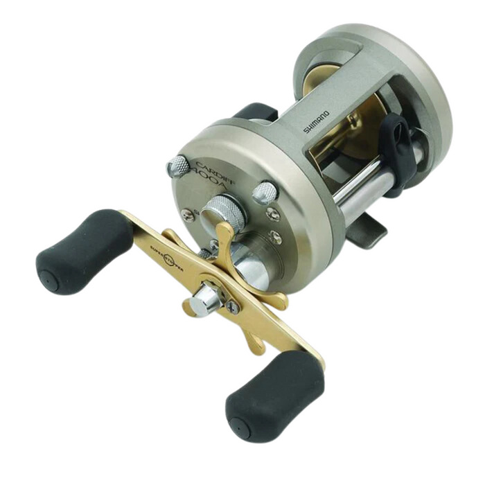 Shimano Cardiff fishing reel with a metallic silver and gold body, featuring ergonomic black handles and precision adjustments for smooth fishing tackle performance.
