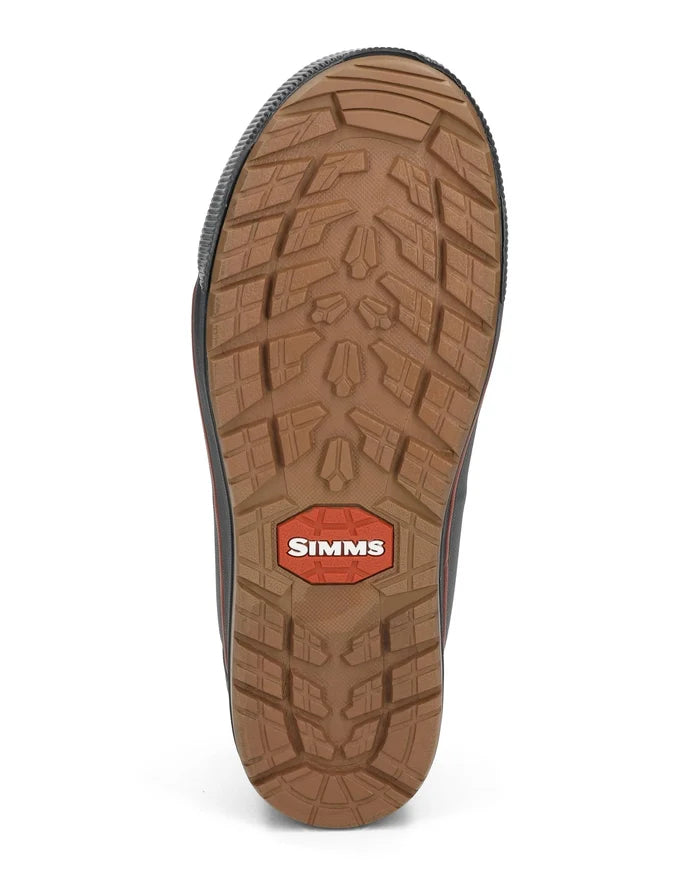 Simms Challenger Slip-On Shoe showing the brown rubber sole with deep tread pattern and red Simms logo for traction and durability in fishing environments.