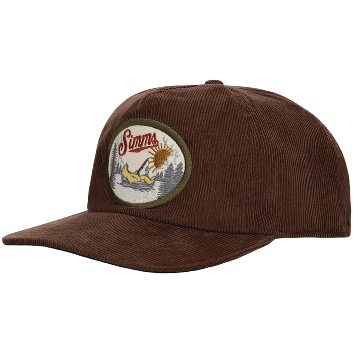 Simms Double Haul Corduroy Cap in brown featuring a rounded patch with outdoor fishing embroidery, designed with a curved brim and textured corduroy fabric.
