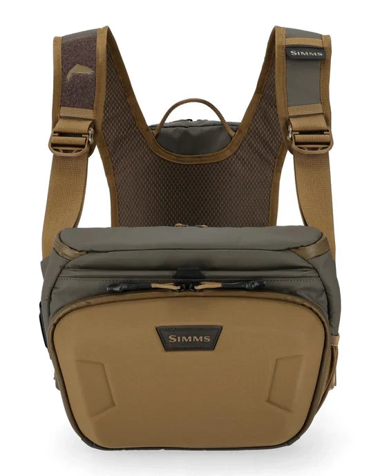 Simms Headwaters Chest Pack in olive and tan colors with padded straps, multiple zippered compartments, and breathable mesh back designed for fishing tackle organization.