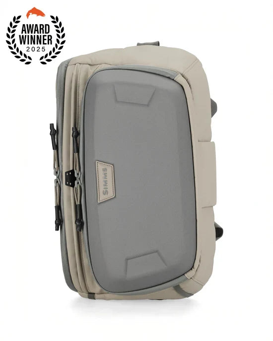 Simms Headwaters Sling Pack in neutral tones with a sturdy, compact design featuring multiple zippered compartments, ideal for organizing fishing tackle and gear.