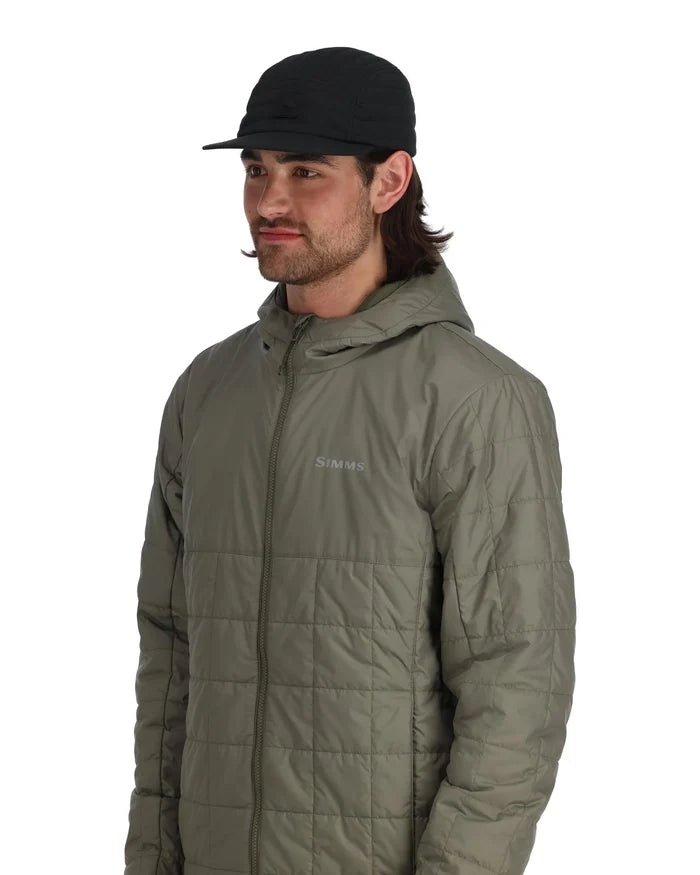 Man wearing a black Simms Insulated Ballcap with a curved brim and quilted olive green jacket, shown from the waist up in a studio setting.