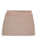 Simms Skort - Women's in beige, featuring a sleek, smooth fabric with a wide elastic waistband and subtle brand logo on the lower hem, designed for comfort and active outdoor wear.