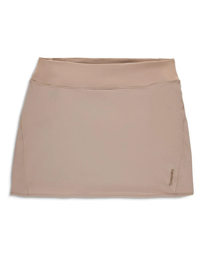 Simms Skort - Women's in beige, featuring a sleek, smooth fabric with a wide elastic waistband and subtle brand logo on the lower hem, designed for comfort and active outdoor wear.