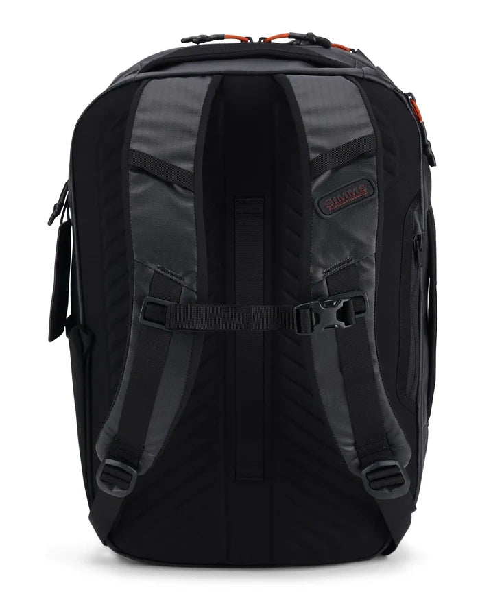Simms Tailwind Backpack shown from the back, featuring padded adjustable shoulder straps, a chest buckle, and durable dark fabric designed for fishing tackle and outdoor use.