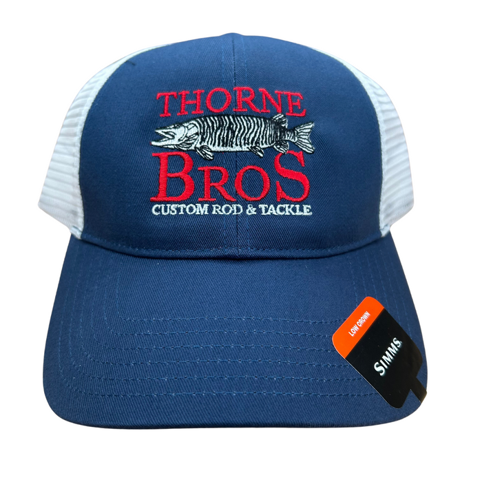 Simms Thorne Bros. Logo Trucker Hat in navy blue with white mesh back, featuring red embroidered "Thorne Bros" text, a musky fish image, and "Custom Rod & Tackle" slogan on front panel.