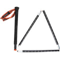 Simms Wading Staff made of carbon material, featuring a textured black grip with an orange wrist strap, shown partially unfolded with measurement markings on the shaft.
