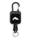 Simms Zinger featuring a black retractable reel with a carabiner clip and a fish silhouette logo, designed for securing fishing tools and accessories.