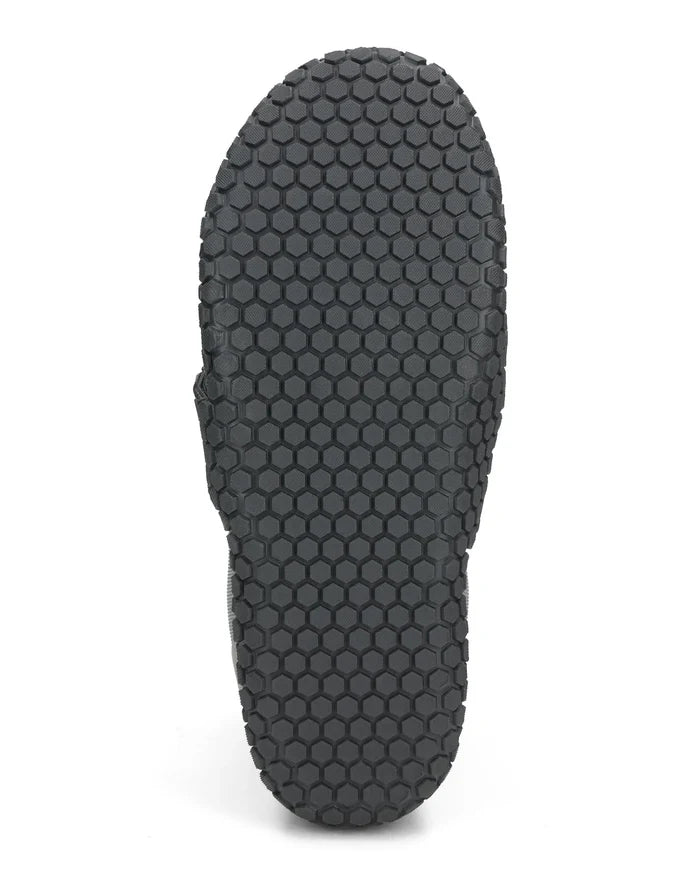 Simms Zip Bootie shown from the sole with a black hexagonal patterned rubber outsole designed for slip resistance and durability in fishing environments.