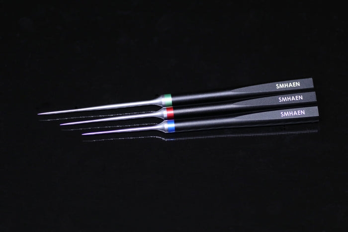 Three Smhaen Dubbing Needle tools with slender pointed tips and black handles, each marked with the brand name and featuring colored bands near the needle tips for easy identification.