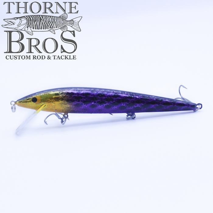 Smithwick Suspending Rattlin' Rogue - Custom Painted Colors fishing lure in purple and gold tones with textured scale design and three treble hooks, displayed on a white background.