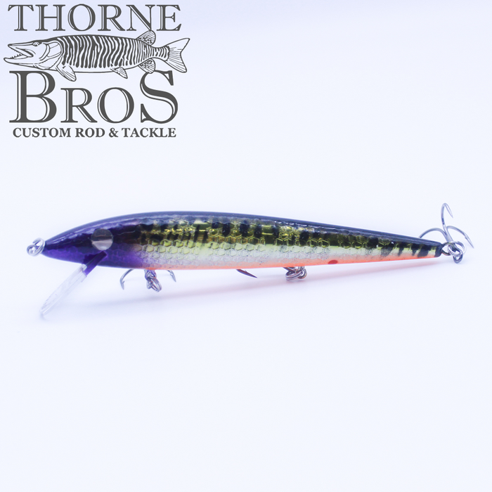 Smithwick Suspending Rattlin' Rogue - Custom Painted Colors fishing lure with a purple and green scaled body, detailed eyes, and multiple treble hooks, designed for musky fishing.