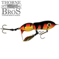 Snaggle Tooth Tackle Mini Beast Prop Bait featuring segmented body with orange, yellow, and black stripes, dual treble hooks, and a small metal propeller for enhanced fishing tackle performance.
