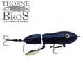 Snaggle Tooth Tackle Super Beast Prop Bait in black with jointed body, metal spinner blade, and treble hooks, designed for musky fishing by Thorne Bros.