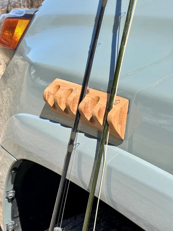 Temperance & Penn CastHitch-Magnetic Rod Holder mounted on a vehicle holding multiple fishing rods securely, showcasing its wooden design and magnetic attachment for fishing tackle.