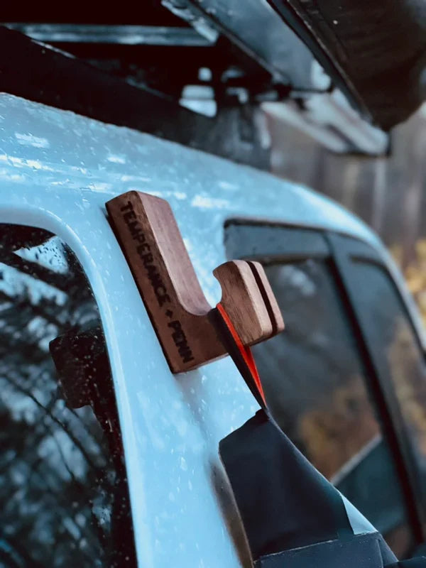 Temperance & Penn Gear Hook-Magnetic wooden magnetic fishing gear hook attached to a vehicle holding a bag, designed for convenient storage of fishing tackle and accessories.